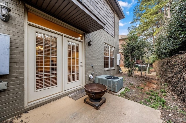 view of patio / terrace featuring central AC unit and an outdoor fire pit