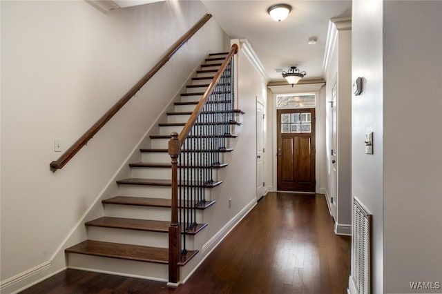 entryway featuring dark wood-type flooring and ornamental molding