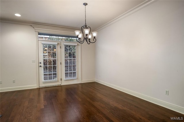 unfurnished dining area featuring a notable chandelier, crown molding, and dark hardwood / wood-style flooring