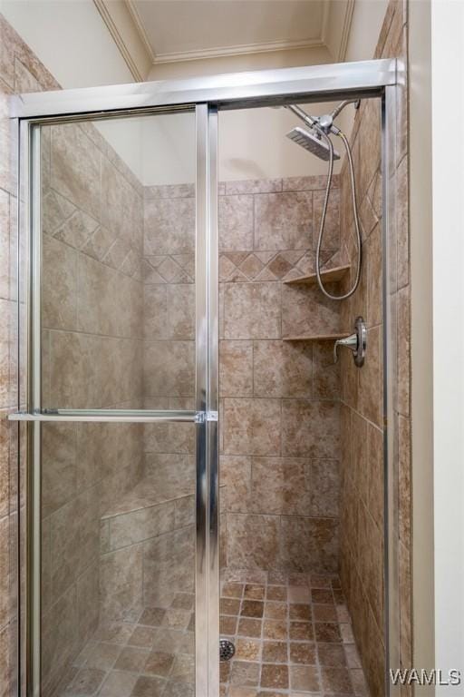 bathroom featuring crown molding and a shower with door