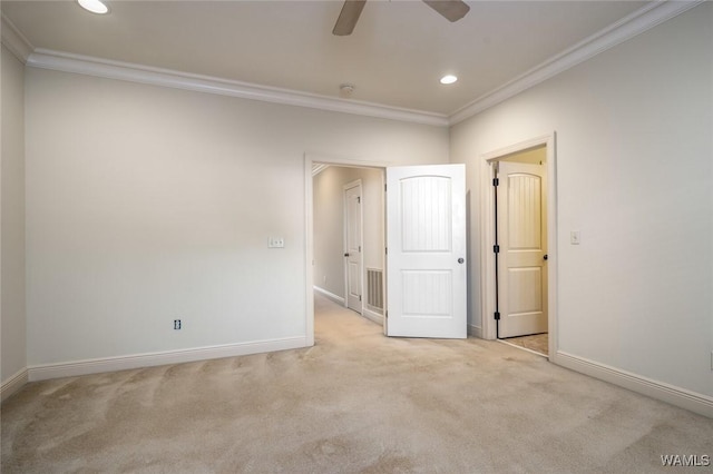 spare room with ceiling fan, light colored carpet, and ornamental molding