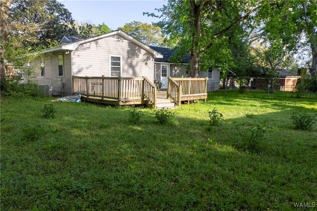 2516 17th Ave, Northport, AL 35476 - rear view of property with fence, a lawn, cooling unit, and a deck
