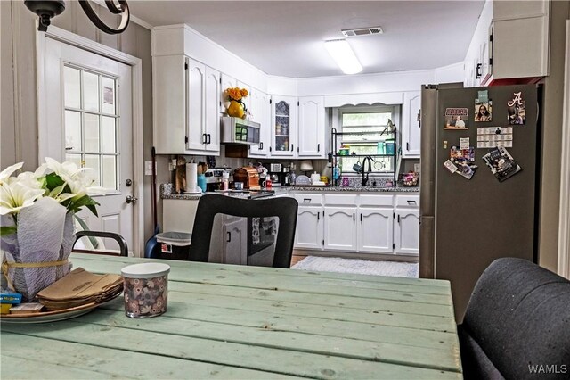 2516 17th Ave, Northport, AL 35476 - kitchen featuring a sink, white cabinets, visible vents, and appliances with stainless steel finishes