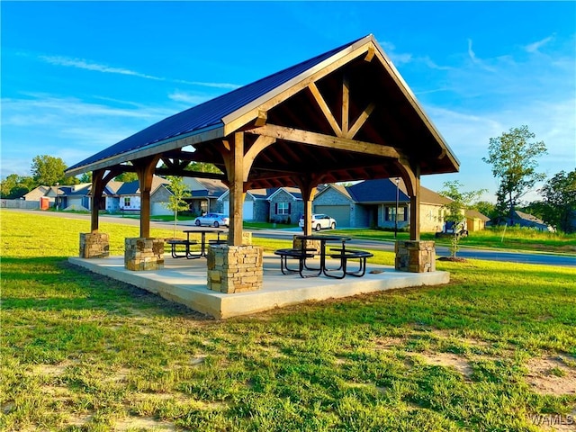 view of property's community with a gazebo, a patio area, and a lawn