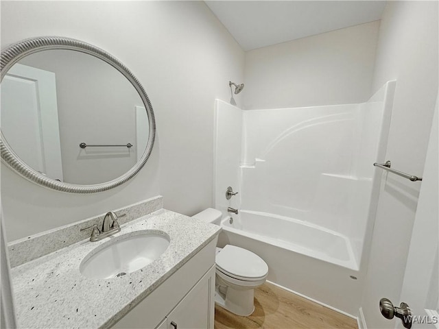 full bathroom featuring vanity, wood-type flooring, bathtub / shower combination, and toilet