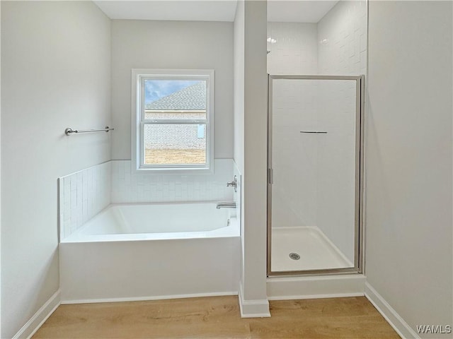 bathroom with plus walk in shower and hardwood / wood-style floors