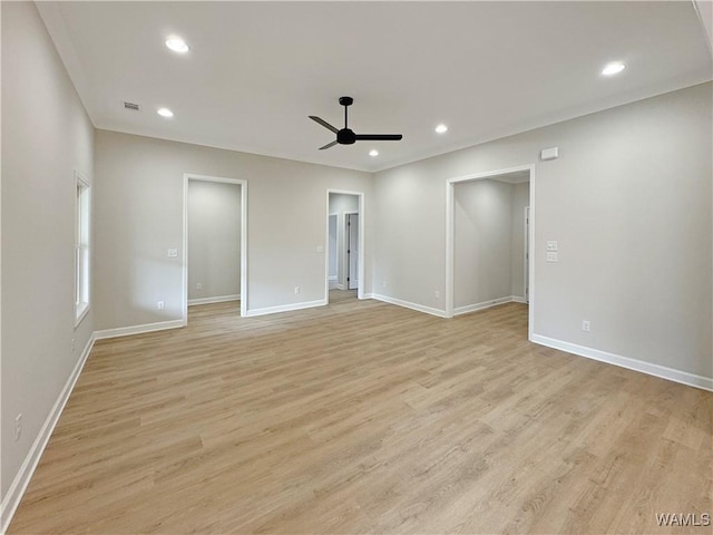 empty room featuring ceiling fan and light wood-type flooring