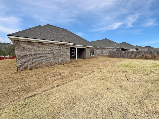 rear view of property with a yard