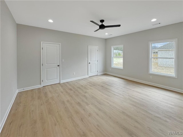 empty room featuring ceiling fan and light hardwood / wood-style floors