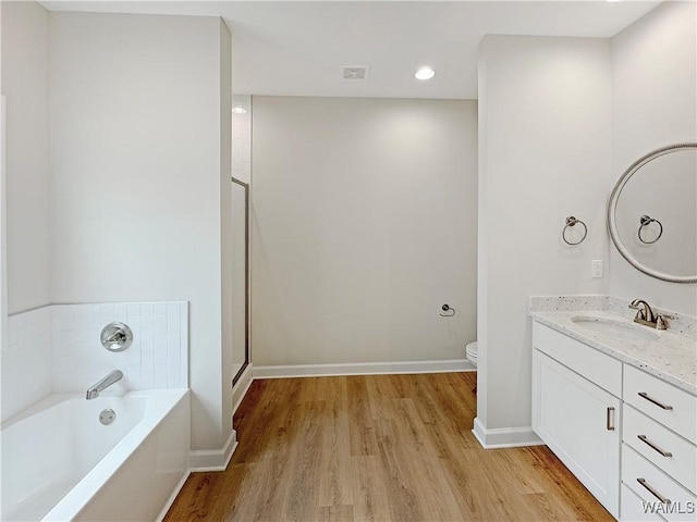 full bathroom with vanity, plus walk in shower, wood-type flooring, and toilet