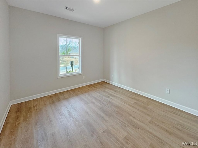 unfurnished room with light hardwood / wood-style floors