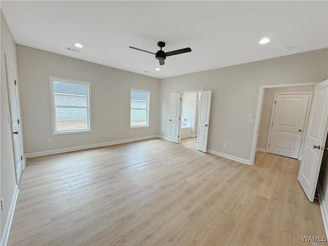 unfurnished bedroom with ensuite bath, light hardwood / wood-style floors, and ceiling fan