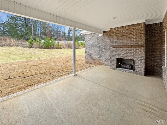 view of patio featuring an outdoor brick fireplace