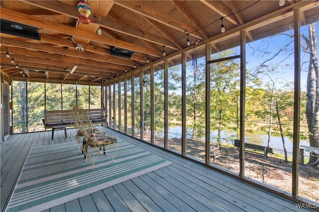 unfurnished sunroom featuring a water view and a healthy amount of sunlight