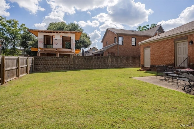 view of yard featuring entry steps, a patio, an outdoor structure, and a fenced backyard