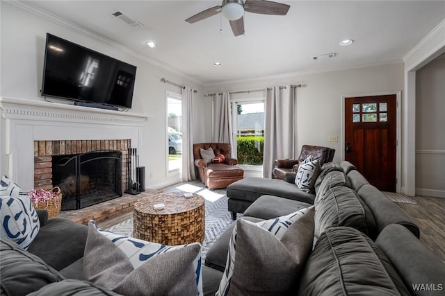 living room with ornamental molding, a fireplace, and visible vents