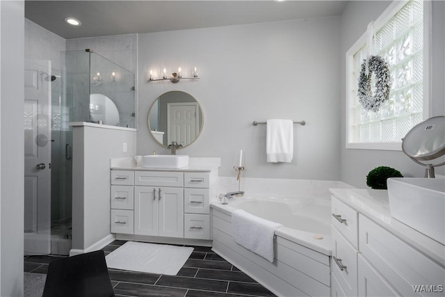 2603 Lauren St, Northport, AL 35475 - full bathroom featuring a shower stall, vanity, a garden tub, and recessed lighting