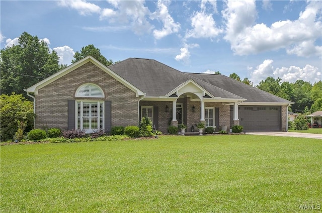 2603 Lauren St, Northport, AL 35475 - view of front of house with brick siding, an attached garage, and a front yard