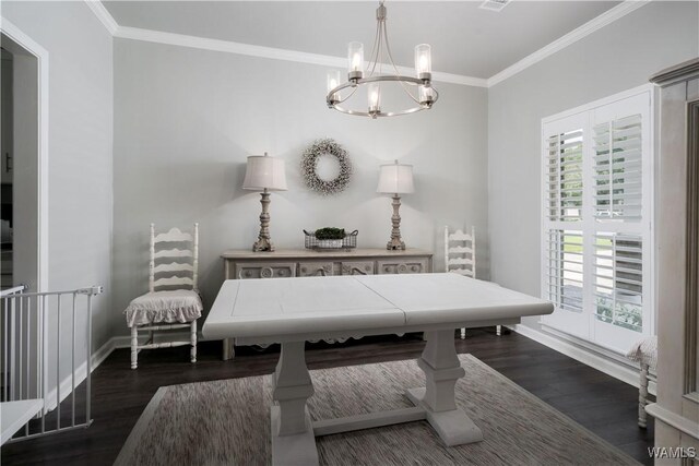2603 Lauren St, Northport, AL 35475 - dining room featuring dark wood finished floors, ornamental molding, a chandelier, and baseboards