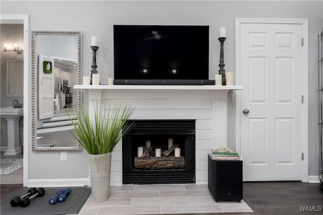 2603 Lauren St, Northport, AL 35475 - detailed view of a fireplace, wood finished floors, and baseboards