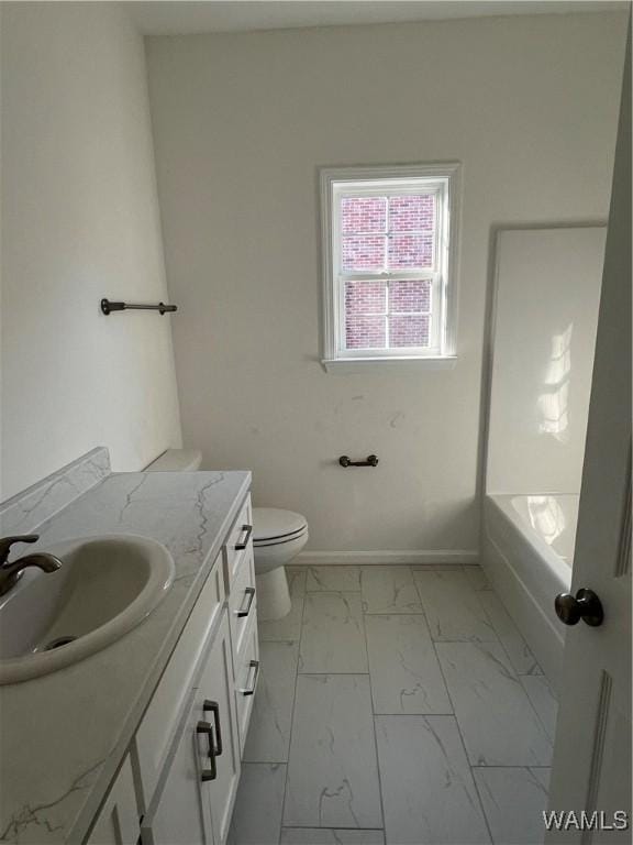 bathroom with toilet, a bathing tub, and vanity