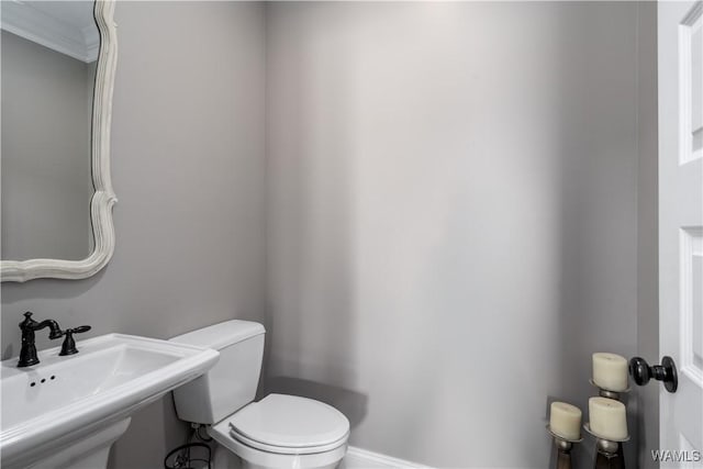 12030 Orlea Ln, Northport, AL 35475 - half bathroom with a sink, toilet, and baseboards