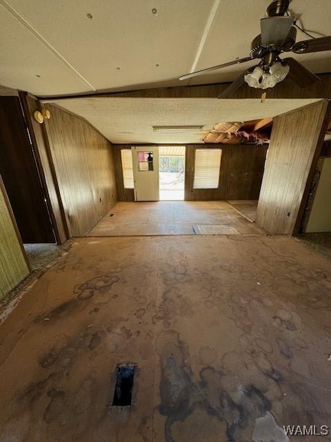 interior space featuring wooden walls and vaulted ceiling