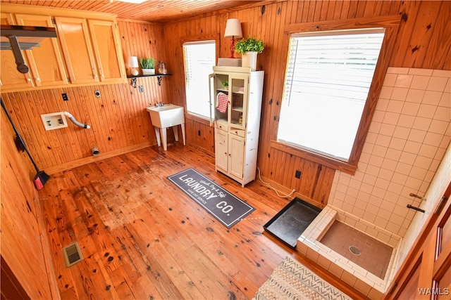 bathroom featuring hardwood / wood-style floors, tile walls, wood ceiling, and wood walls