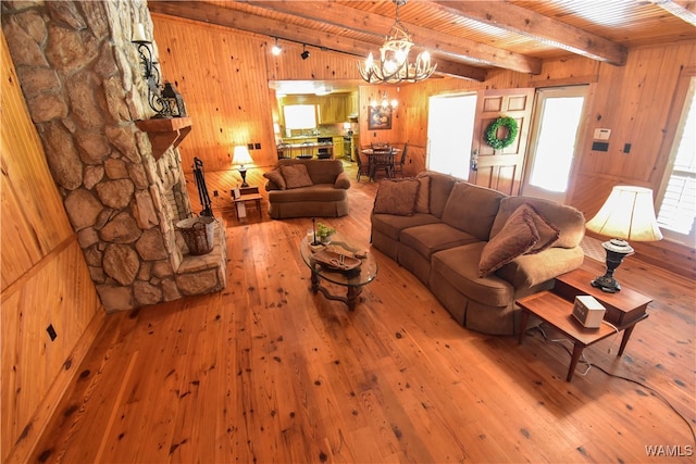 living room featuring wooden ceiling, an inviting chandelier, wooden walls, beam ceiling, and wood-type flooring