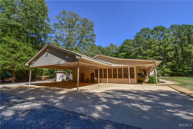 view of front of home featuring a carport and a sunroom