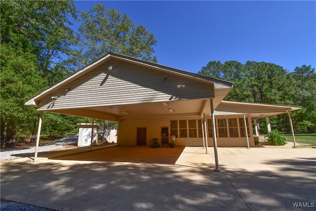 exterior space with a carport and a sunroom