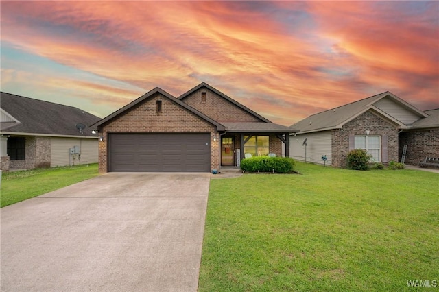 12962 Garden Creek Ln, Northport, AL 35473 - view of front facade featuring brick siding, a front yard, concrete driveway, and an attached garage