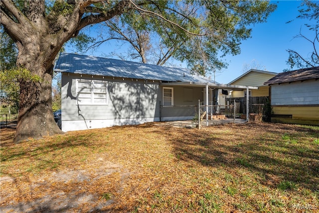 rear view of house featuring a lawn