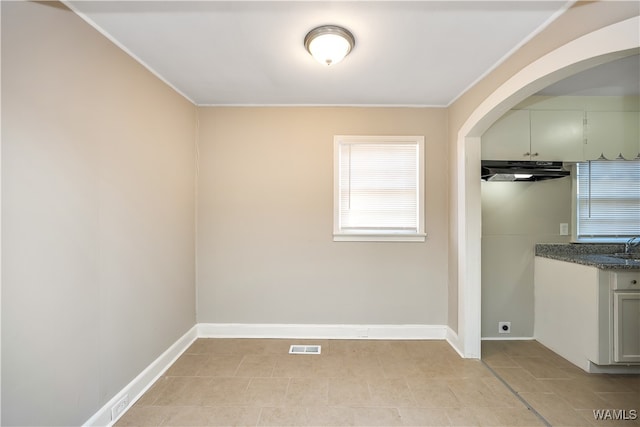 unfurnished dining area with crown molding