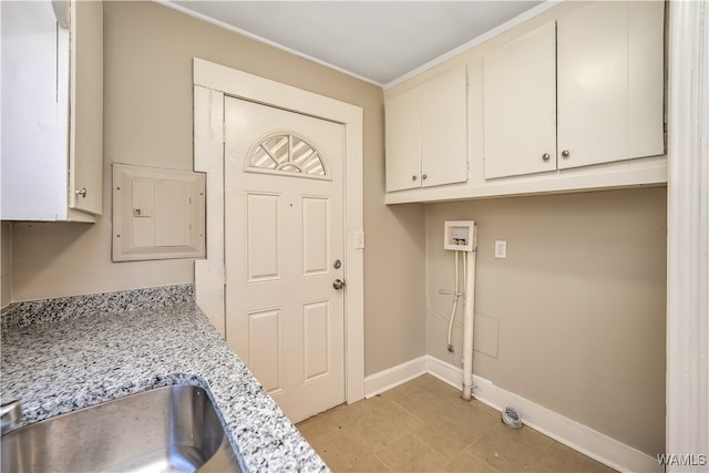 laundry room featuring cabinets, hookup for a washing machine, electric panel, and sink