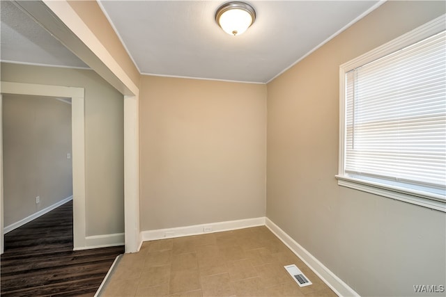 spare room with hardwood / wood-style floors and ornamental molding