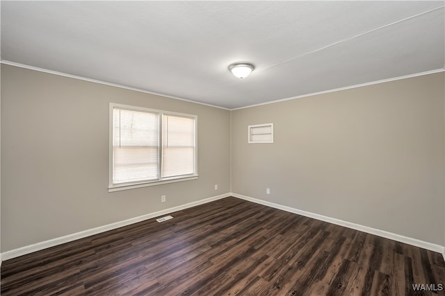 unfurnished room with ornamental molding and dark wood-type flooring