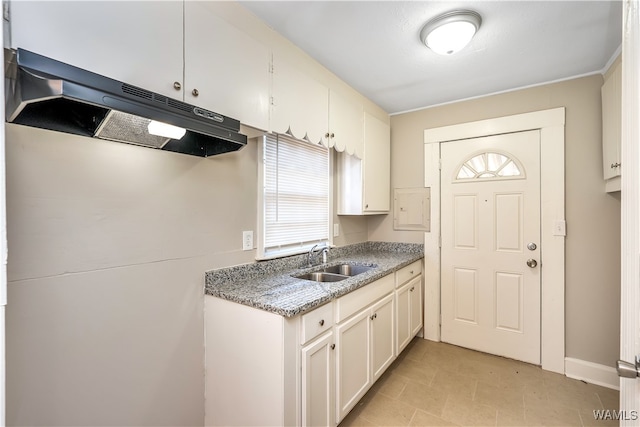 kitchen featuring white cabinetry and sink