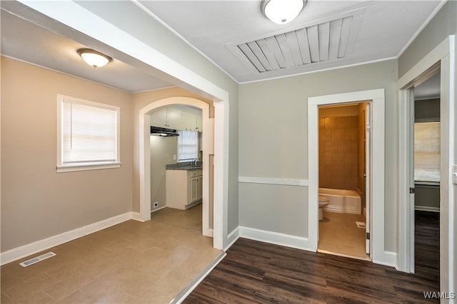 hall with dark hardwood / wood-style floors and ornamental molding