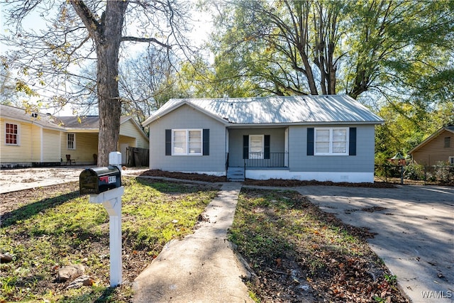 single story home featuring covered porch