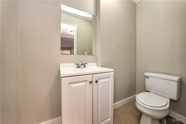 bathroom featuring tile patterned floors, vanity, and toilet