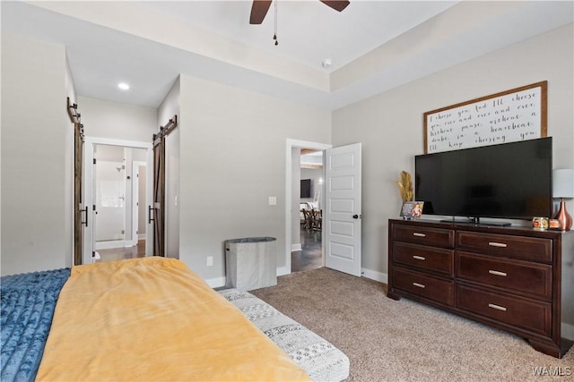 12625 Northside Rd, Northport, AL 35475 - bedroom featuring light carpet, a barn door, connected bathroom, baseboards, and ceiling fan