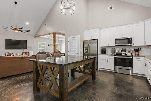 12625 Northside Rd, Northport, AL 35475 - kitchen with appliances with stainless steel finishes, high vaulted ceiling, finished concrete flooring, tasteful backsplash, and white cabinetry