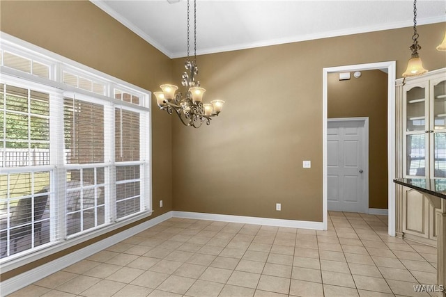 unfurnished room with a notable chandelier, light tile patterned floors, baseboards, and ornamental molding