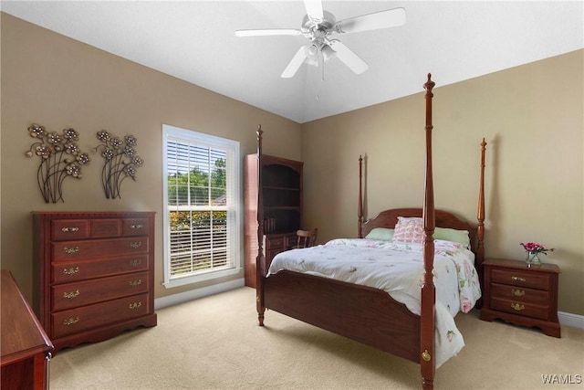 bedroom with light colored carpet, baseboards, a ceiling fan, and vaulted ceiling