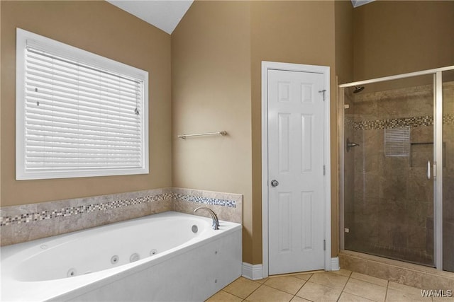 bathroom featuring tile patterned flooring, a shower stall, and a jetted tub