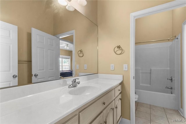 full bath featuring tile patterned flooring, shower / bathtub combination, toilet, and vanity