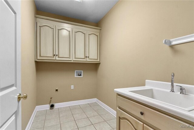 clothes washing area featuring electric dryer hookup, a sink, cabinet space, light tile patterned floors, and hookup for a washing machine