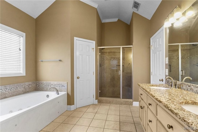 bathroom with a sink, a stall shower, and tile patterned flooring