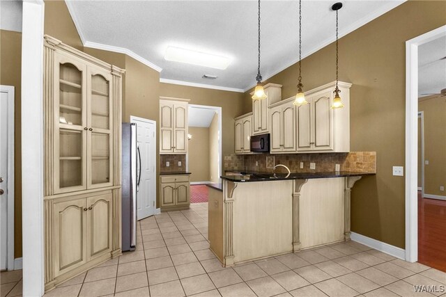 kitchen with light tile patterned flooring, a peninsula, a breakfast bar, and black microwave